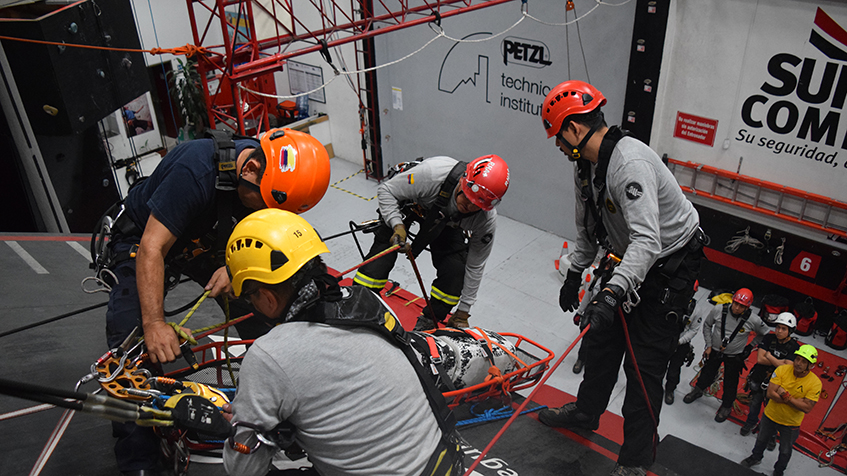 Fotografía de personas en entrenamiiento de salvamento bajando una camilla de un techo